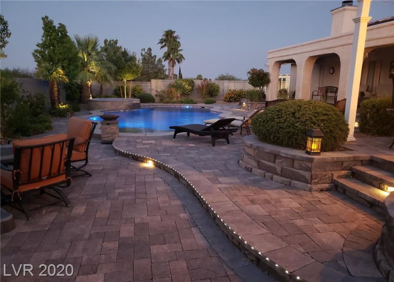Pool and patio at night in Las Vegas home
